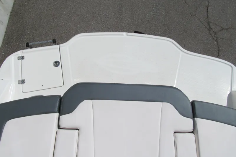 Slide: The Image of 2019 Chaparral 21 H2O Sport boat deck with cushioned seating and storage hatch. - 14