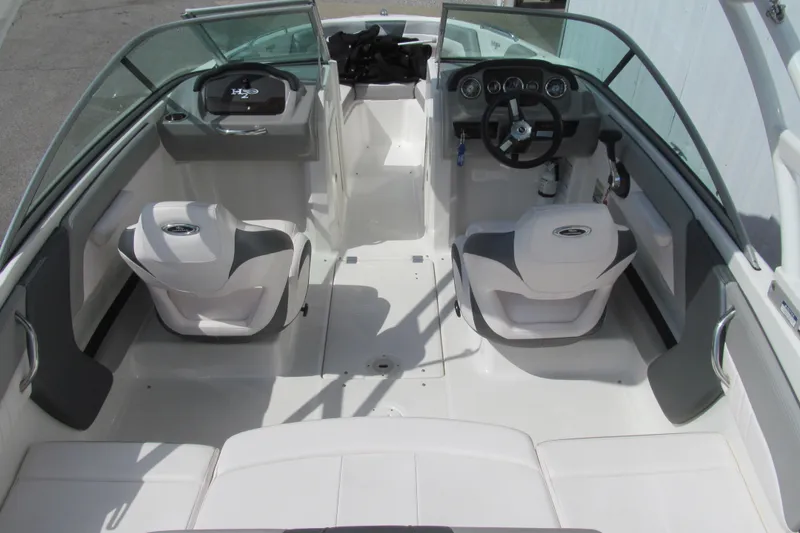 Slide: The Image of 2019 Chaparral 21 H2O Sport boat interior with dual seating and steering console. - 5