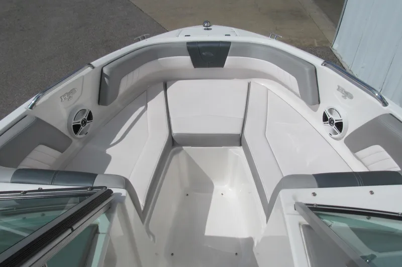Slide: The Image of 2019 Chaparral 21 H2O Sport boat interior with white and gray seating. - 9