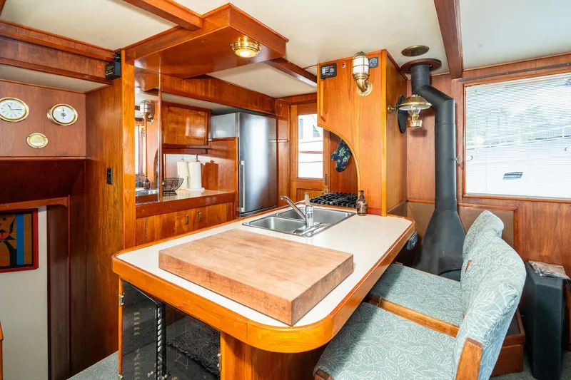 Slide: The Image of Interior of a 1971 Philbrook's Trawler yacht with wooden furnishings. - 12