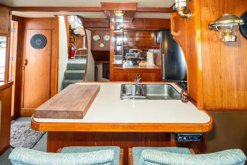 Slide: The Image of Interior of a 1971 Philbrook's Trawler yacht with wooden furnishings. - 13