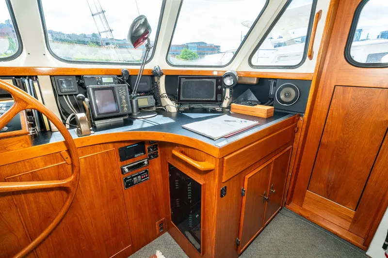 Slide: The Image of Interior view of a 1971 Philbrook's Trawler cockpit with wooden paneling. - 21