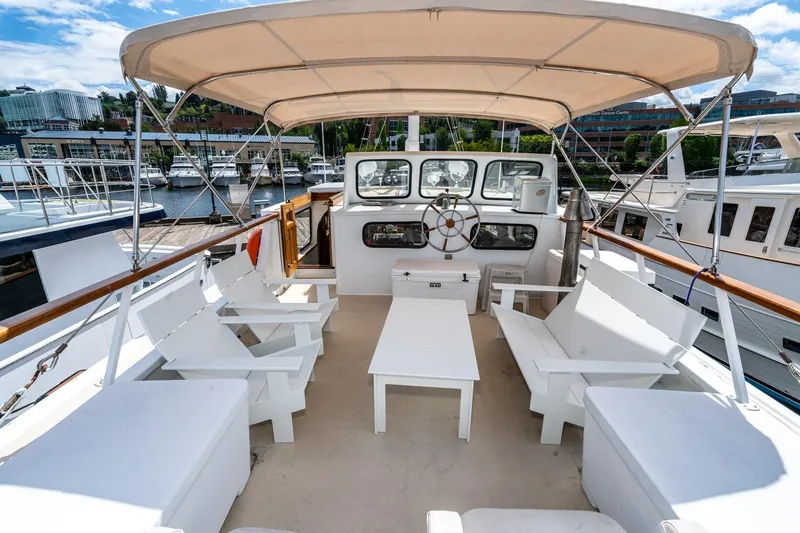 Slide: The Image of Philbrook's 1971 Trawler with spacious deck and seating area in harbor. - 26