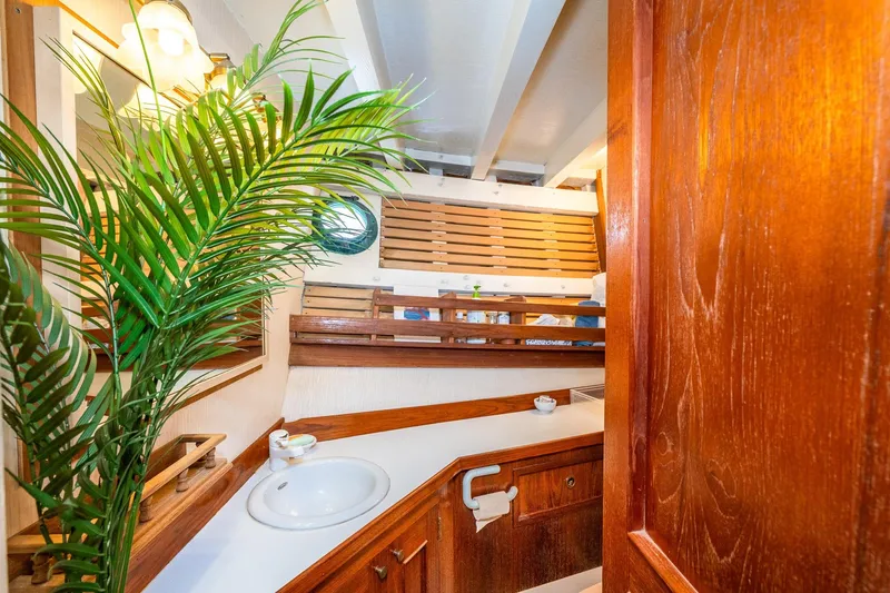 Slide: The Image of Interior of 1971 Philbrook's Trawler with wood paneling and plant. - 48
