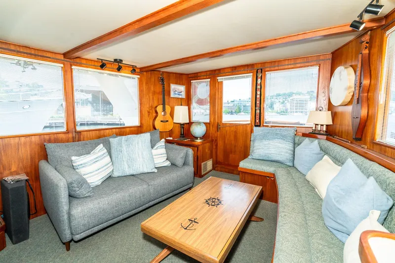 Slide: The Image of Interior of a 1971 Philbrook's Trawler with cozy sofas and wooden decor. - 6
