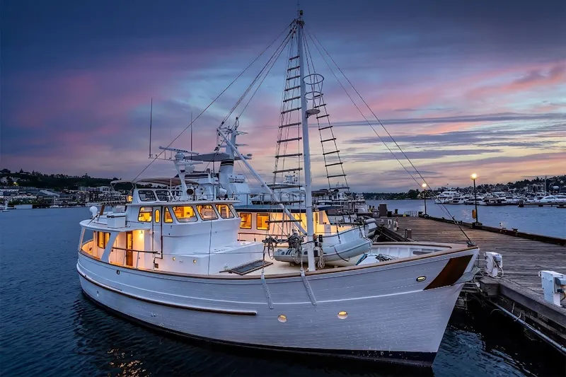 Slide: The Image of 1971 Philbrook's Trawler docked at sunset, showcasing elegant design and serene waterfront setting. - 80