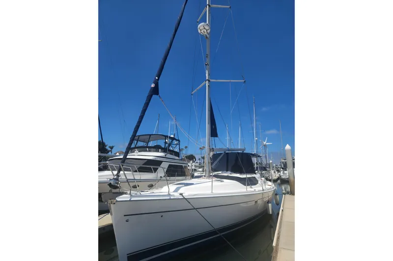 The Image of 2008 Hunter 450 sailboat docked at marina under clear blue sky. - 0