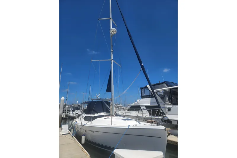 Slide: The Image of 2008 Hunter 450 sailboat docked at marina under clear blue sky. - 1