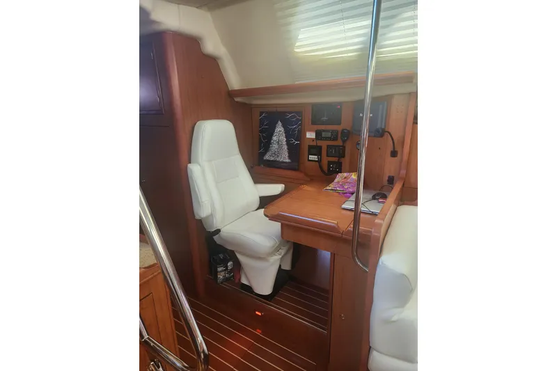 Slide: The Image of 2008 Hunter 450 yacht interior with navigation station and white captain's chair. - 10