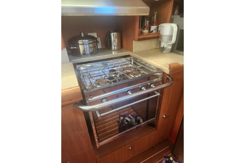 Slide: The Image of Compact kitchen with a stainless steel stove and oven in a 2008 Hunter 450 yacht. - 13
