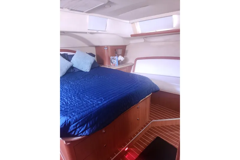 Slide: The Image of Luxurious cabin interior of 2008 Hunter 450 yacht with blue bedding and wooden accents. - 15