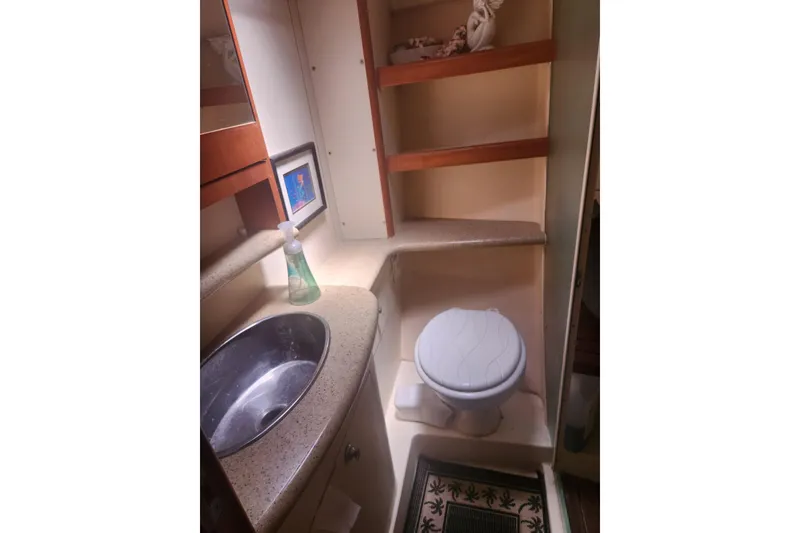 Slide: The Image of Compact bathroom in 2008 Hunter 450 yacht with sink, toilet, and shelves. - 19