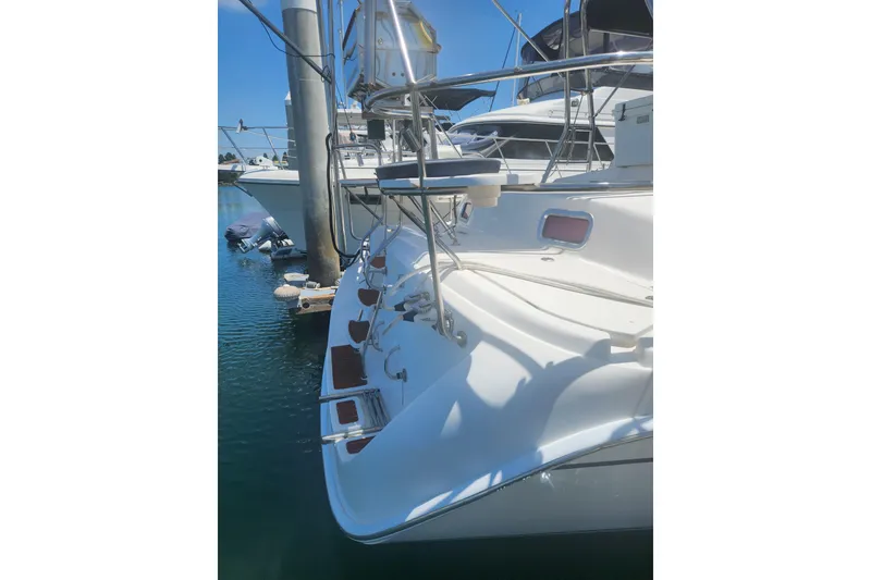 Slide: The Image of Hunter 450 sailboat from 2008 docked in a marina, showing stern details. - 2