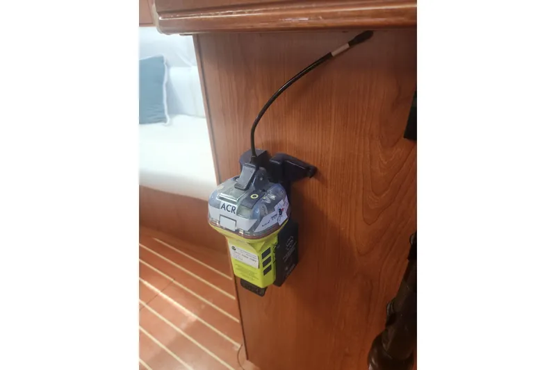 Slide: The Image of Emergency beacon mounted on wooden panel inside 2008 Hunter 450 boat cabin. - 21