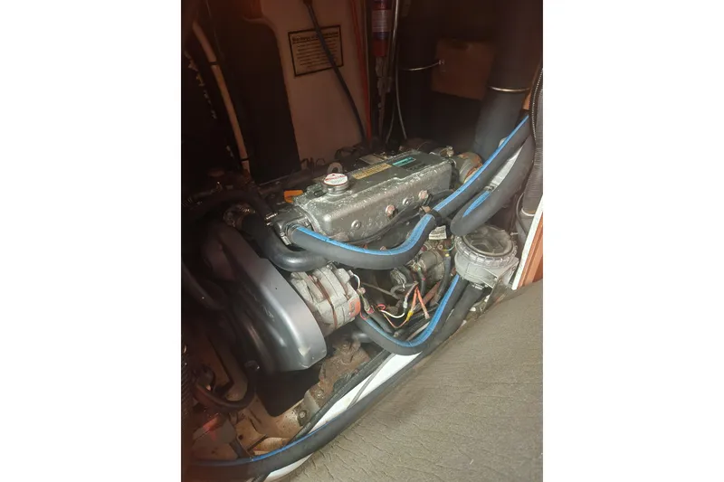 Slide: The Image of Engine compartment of a 2008 Hunter 450, showcasing mechanical components and wiring. - 23
