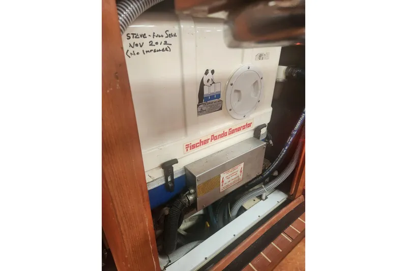 Slide: The Image of Fischer Panda generator inside a 2008 Hunter 450 yacht, with maintenance notes visible. - 24