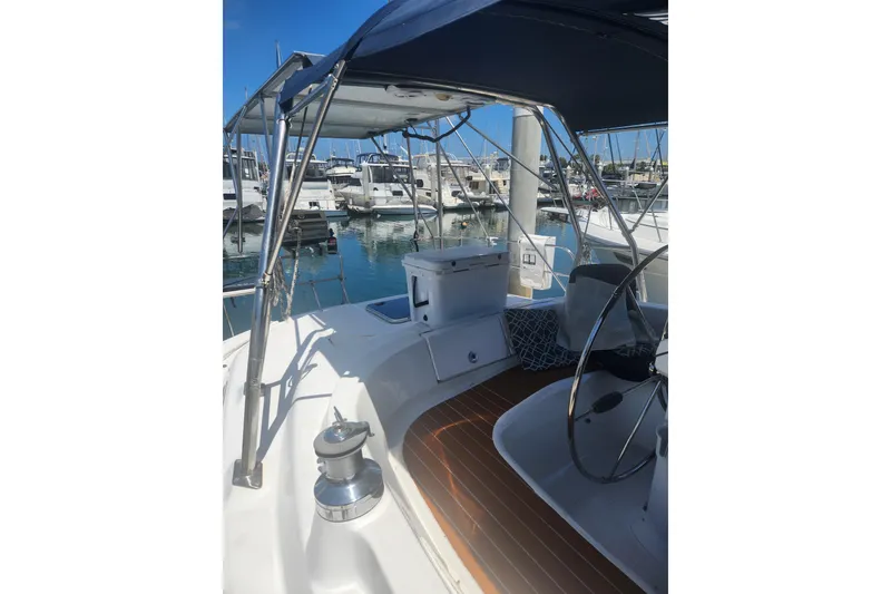 Slide: The Image of 2008 Hunter 450 sailboat cockpit with steering wheel, docked at marina. - 3