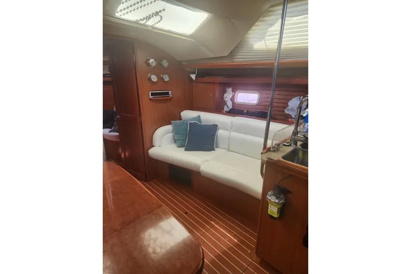 Slide: The Image of Interior of 2008 Hunter 450 yacht with white seating and wooden accents. - 9