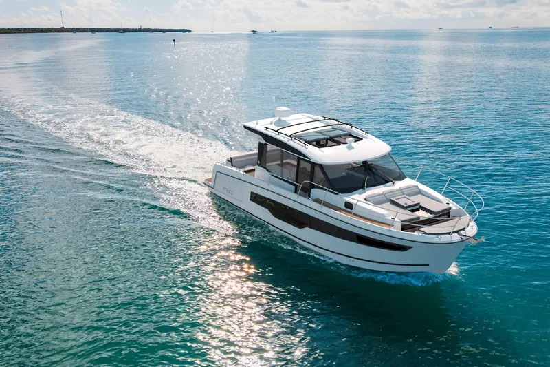 The Image of 2027 Jeanneau NC 1095 Coupe Series 2 cruising on clear blue water. - 0