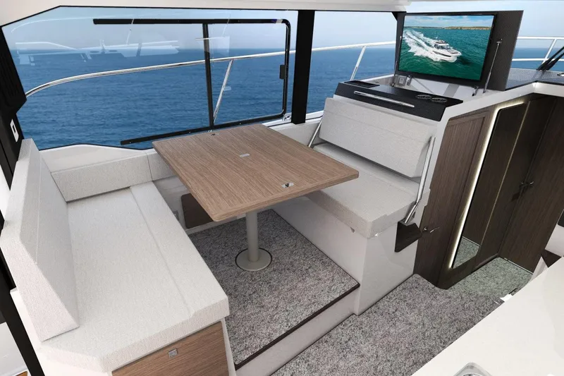 Slide: The Image of Manufacturer Provided Image: Interior of 2026 Jeanneau NC 1095 Coupe Series 2 with dining area and ocean view. - 4