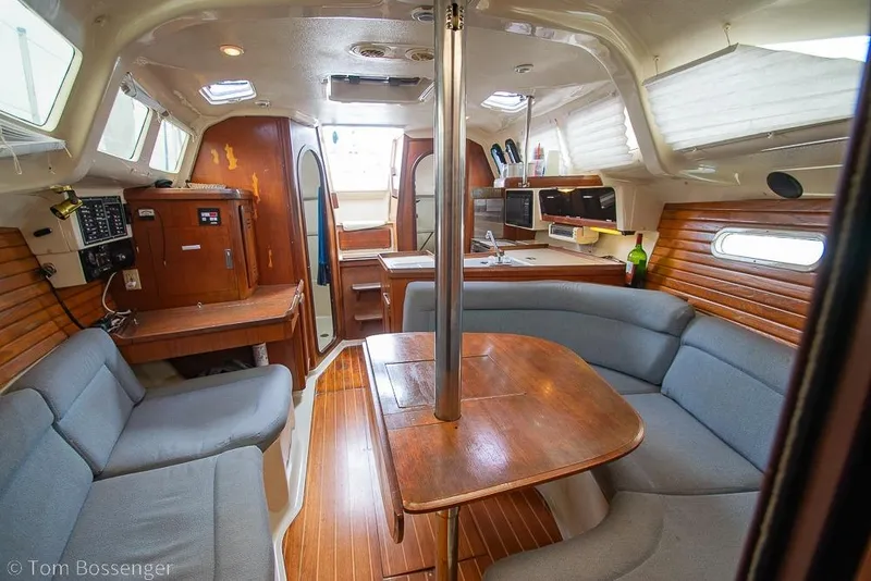 Slide: The Image of Interior of a 1995 Hunter 336 sailboat with cozy seating and wooden finishes. - 14