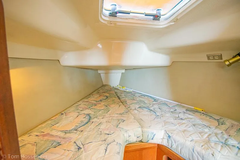 Slide: The Image of Interior cabin of a 1995 Hunter 336 sailboat with a cozy V-berth. - 16