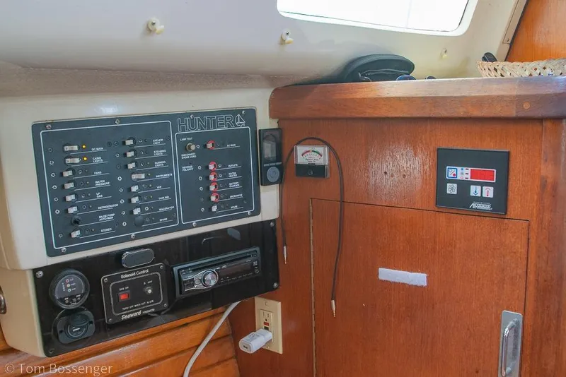 Slide: The Image of Control panel of a 1995 Hunter 336 sailboat with various switches and gauges. - 17