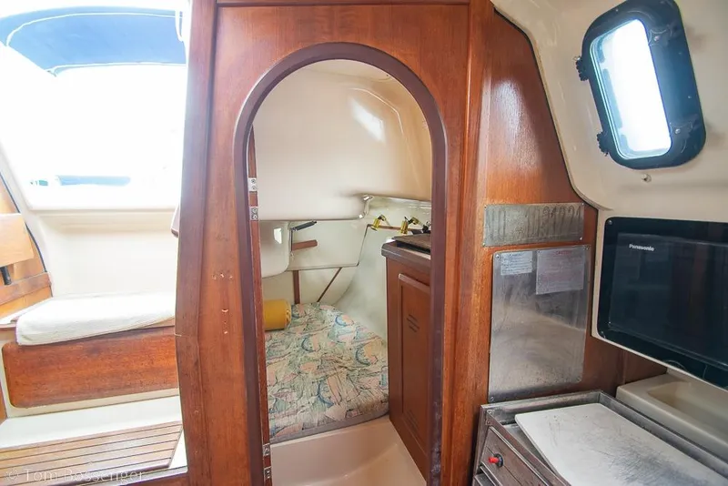 Slide: The Image of Interior of a 1995 Hunter 336 sailboat cabin with wood finish and cozy seating. - 18