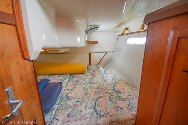 Slide: The Image of Cozy cabin interior of 1995 Hunter 336 sailboat with patterned bedding and wooden accents. - 19