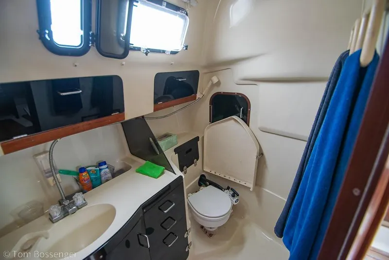 Slide: The Image of Interior of a 1995 Hunter 336 sailboat bathroom with sink, toilet, and storage. - 20