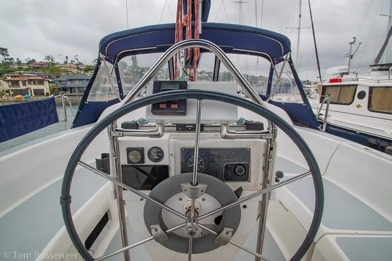 Slide: The Image of Cockpit view of a 1995 Hunter 336 sailboat with steering wheel and navigation instruments. - 23