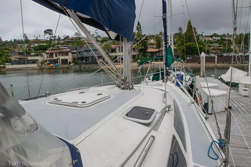 Slide: The Image of Sailboat Hunter 336 (1995) docked in a marina with waterfront homes in the background. - 27
