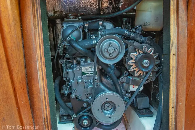 Slide: The Image of Engine compartment of a 1995 Hunter 336 sailboat, showcasing mechanical components and belts. - 33