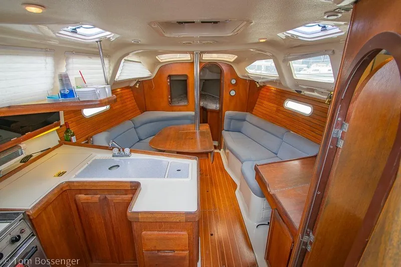 Slide: The Image of Interior of a 1995 Hunter 336 sailboat with wood finish and cozy seating area. - 6