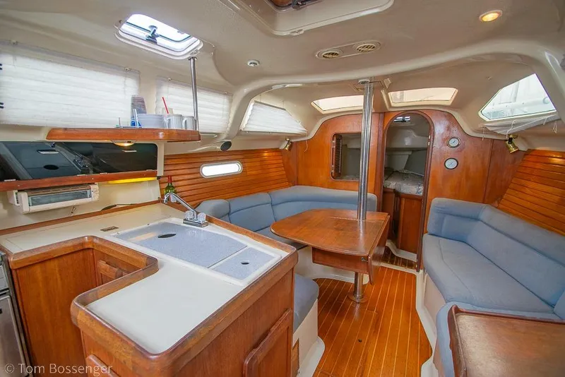 Slide: The Image of Interior of a 1995 Hunter 336 sailboat with cozy seating and wooden finishes. - 7