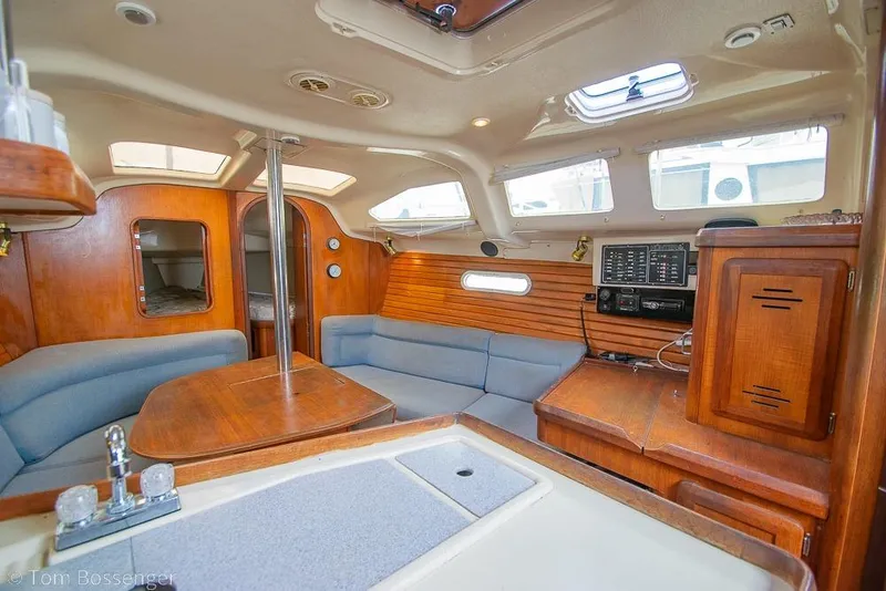 Slide: The Image of Interior of a 1995 Hunter 336 sailboat with wood finish and cozy seating area. - 9