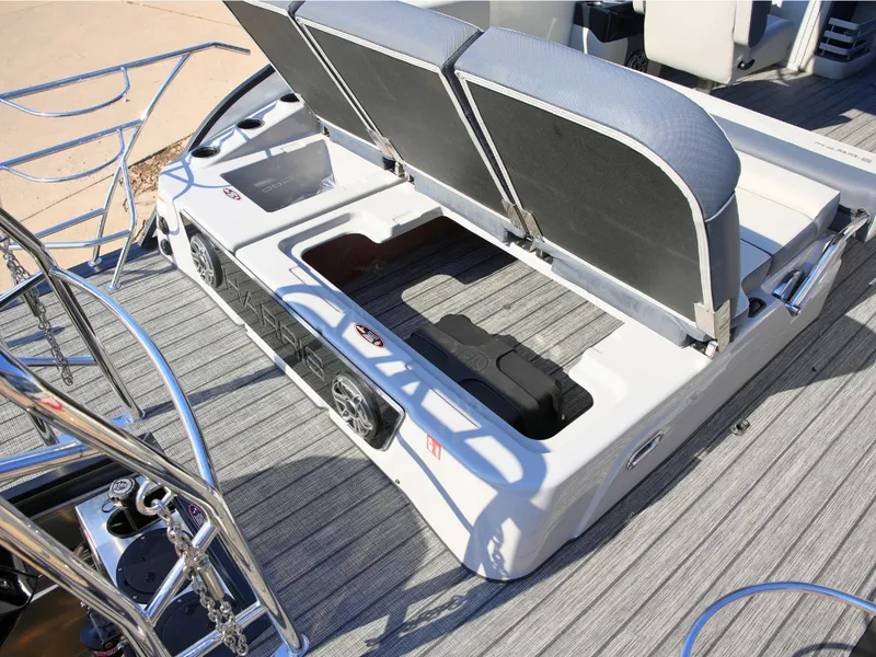 Slide: The Image of The image shows the storage area of a 2027 Harris Grand Mariner 250 with gray upholstery. - 34