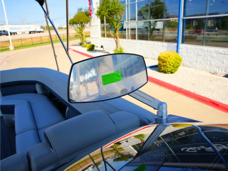 Slide: The Image of The image shows the cockpit of a 2027 Harris Grand Mariner 250 with a rearview mirror. - 25