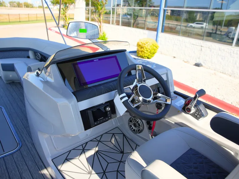 Slide: The Image of The image shows the helm of a 2027 Harris Grand Mariner 250 with a modern steering wheel and touchscreen. - 20