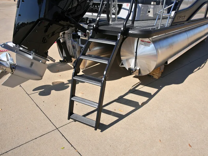 Slide: The Image of A 2027 Harris Grand Mariner 250 with a black ladder and silver pontoon. - 4