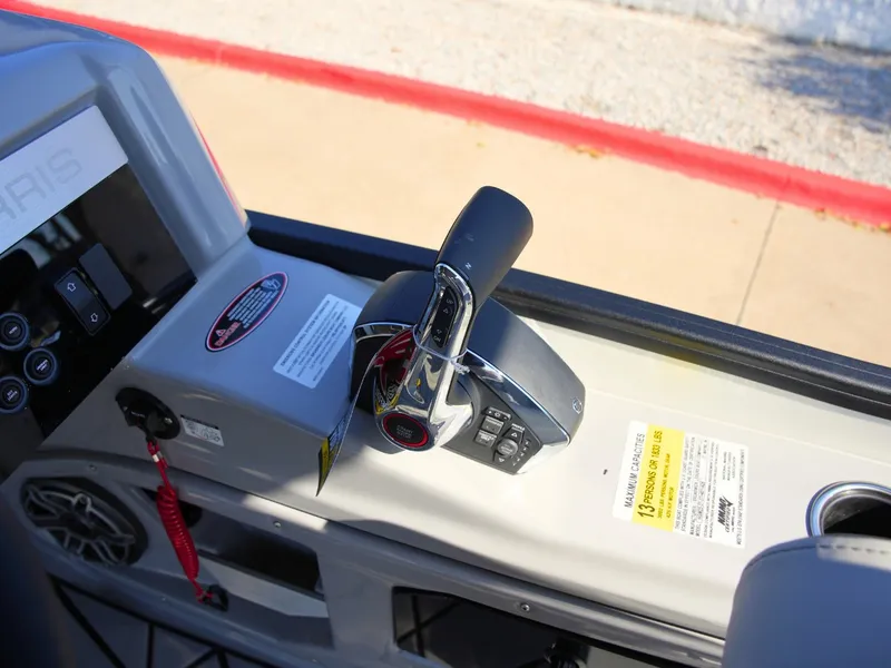 Slide: The Image of Close-up of the helm of a 2027 Harris Grand Mariner 250, featuring throttle and controls. - 24