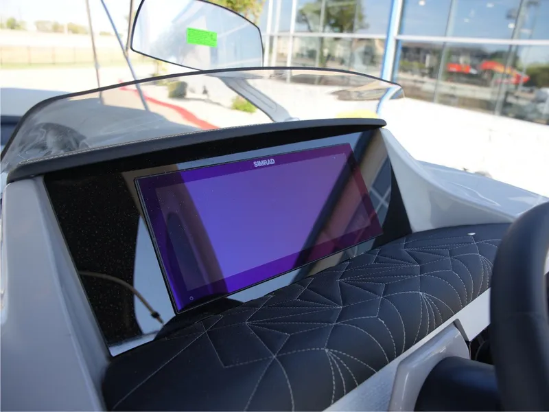 Slide: The Image of The image shows the cockpit of a 2027 Harris Grand Mariner 250 with a large display. - 22