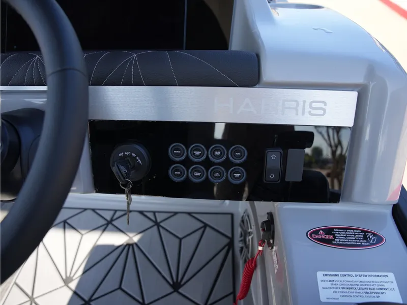 Slide: The Image of The image shows the helm of a Harris Grand Mariner 250 with modern controls and sleek design. - 23