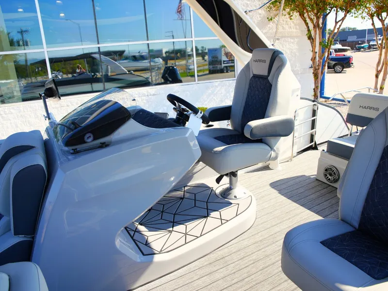 Slide: The Image of The image shows the cockpit of a 2027 Harris Grand Mariner 250 with luxurious seating. - 18