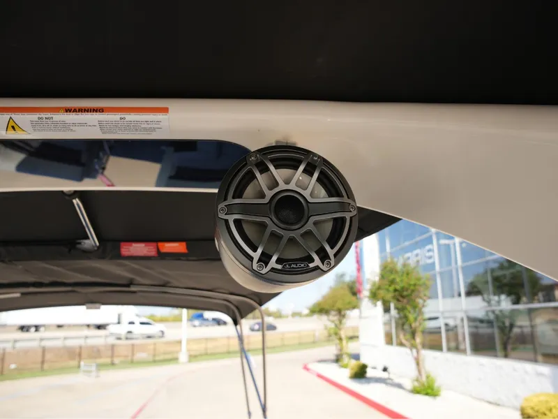 Slide: The Image of A speaker is mounted on the ceiling of a boat, with a warning label nearby. - 29