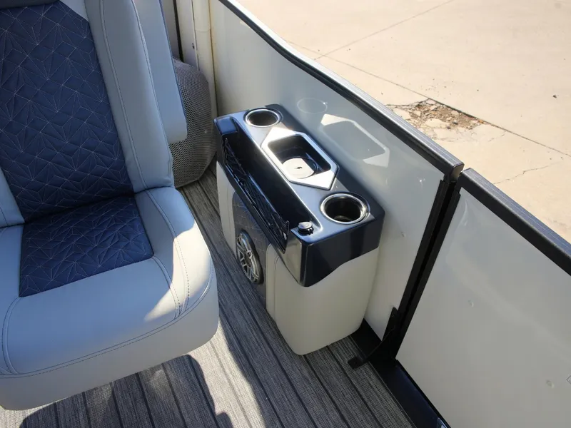 Slide: The Image of A sleek seating area with blue and gray upholstery and a cup holder. - 17