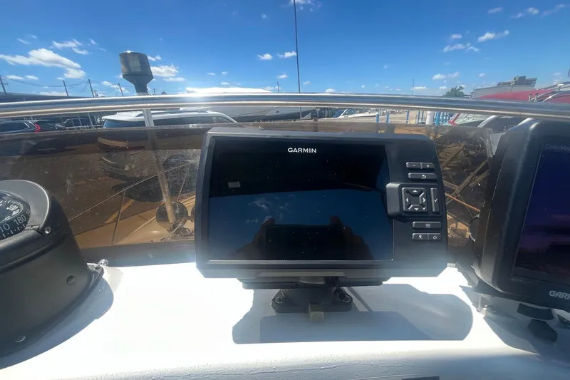Slide: The Image of Garmin navigation system on 1988 Seafox 29 Flybridge boat under clear blue sky. - 10