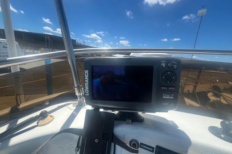 Slide: The Image of Lowrance Elite-7 GPS on 1988 Seafox 29 Flybridge boat under clear blue sky. - 11