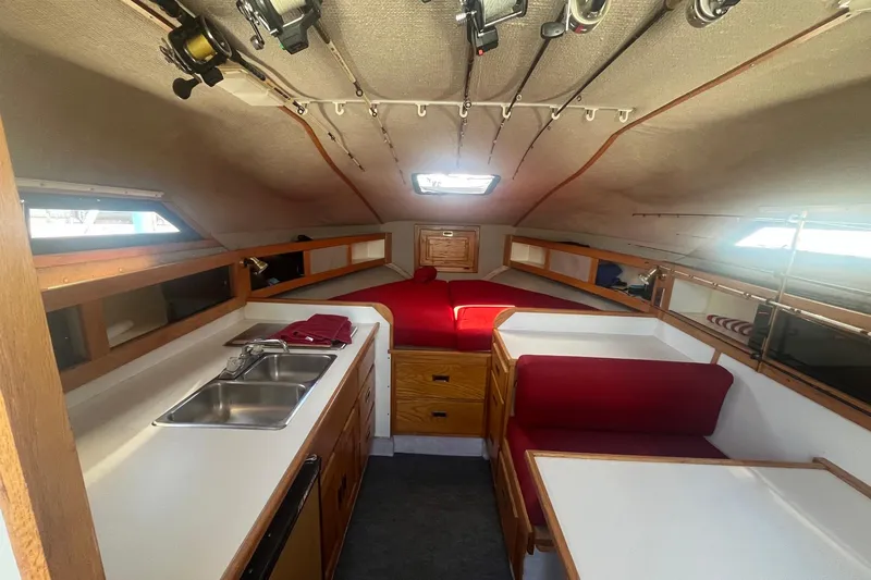 Slide: The Image of Interior of 1988 Seafox 29 Flybridge boat with kitchen and seating area. - 14