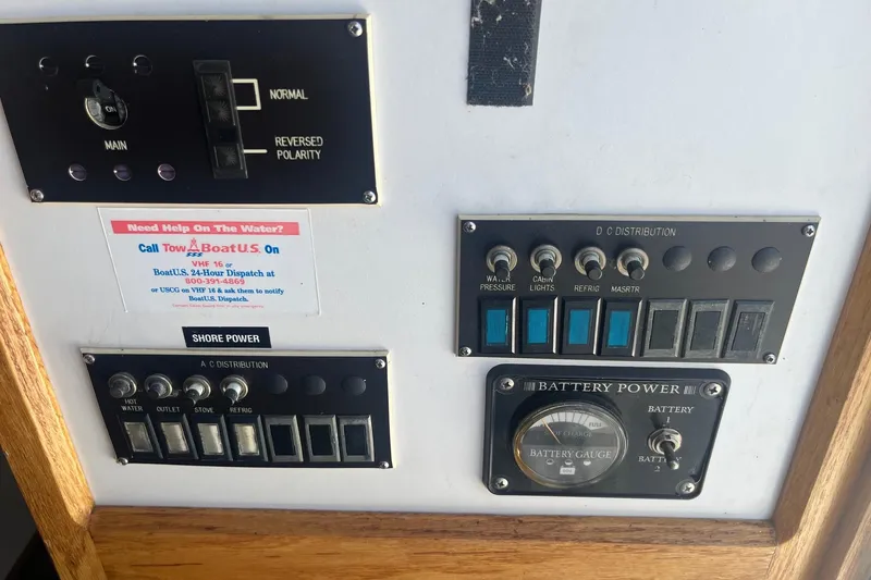 Slide: The Image of Control panel of a 1988 Seafox 29 Flybridge boat with various switches and gauges. - 22
